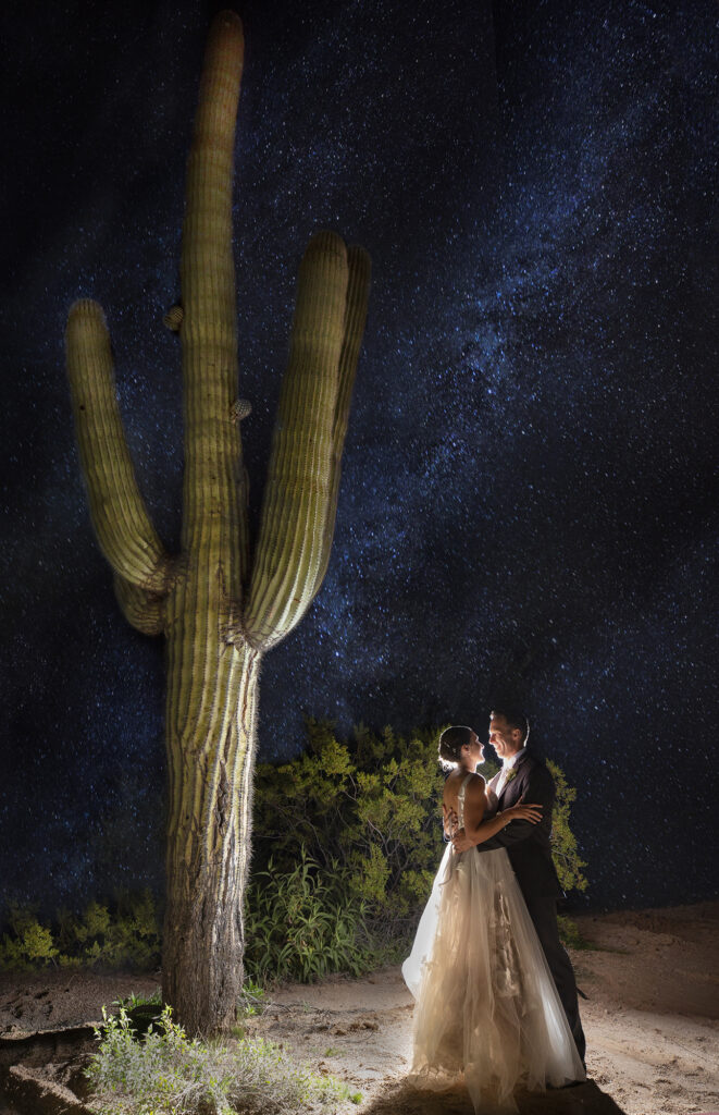 Newlywed couple embracing under a to